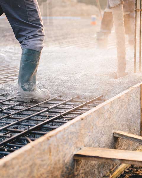 Men pouring concrete foundation