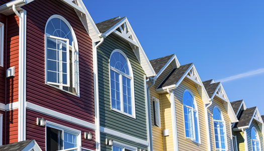 Row of houses with brightly colored siding